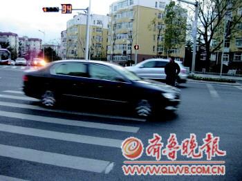 一位行人在燕兒島路與寧夏路路口闖紅燈被困在車流中。